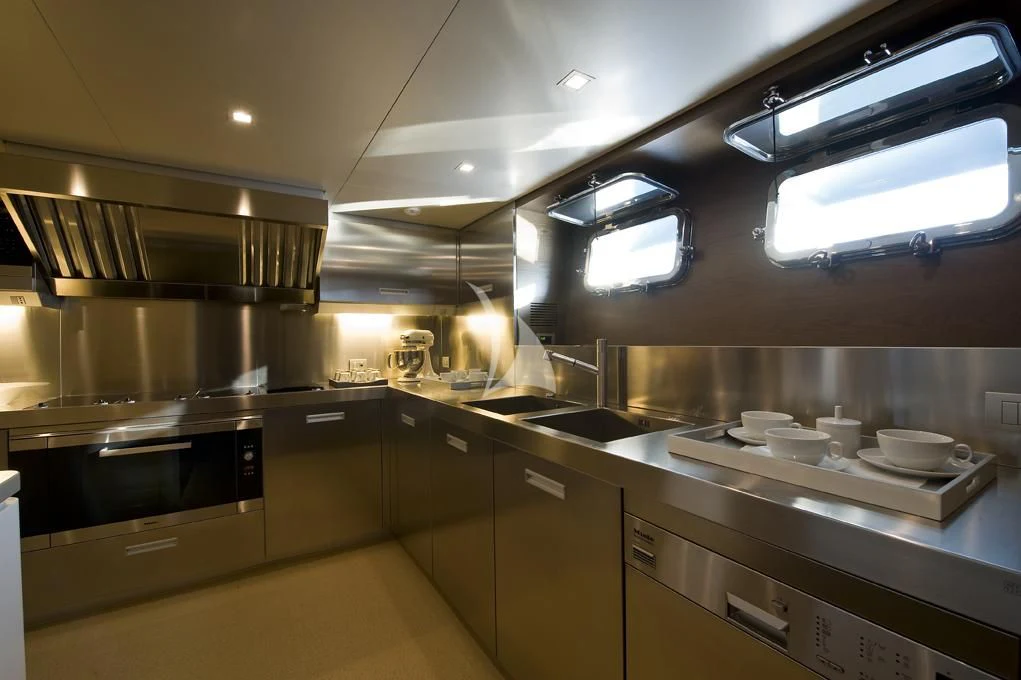 a kitchen with stainless steel appliances aboard NAIA Yacht for Sale