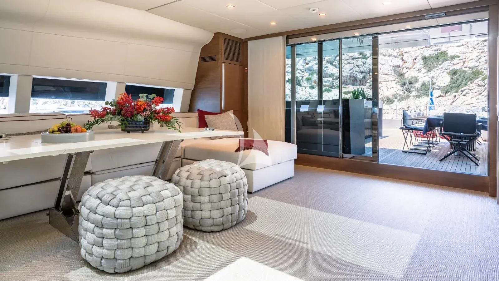a living room with a couch and a table aboard NAIA Yacht for Sale