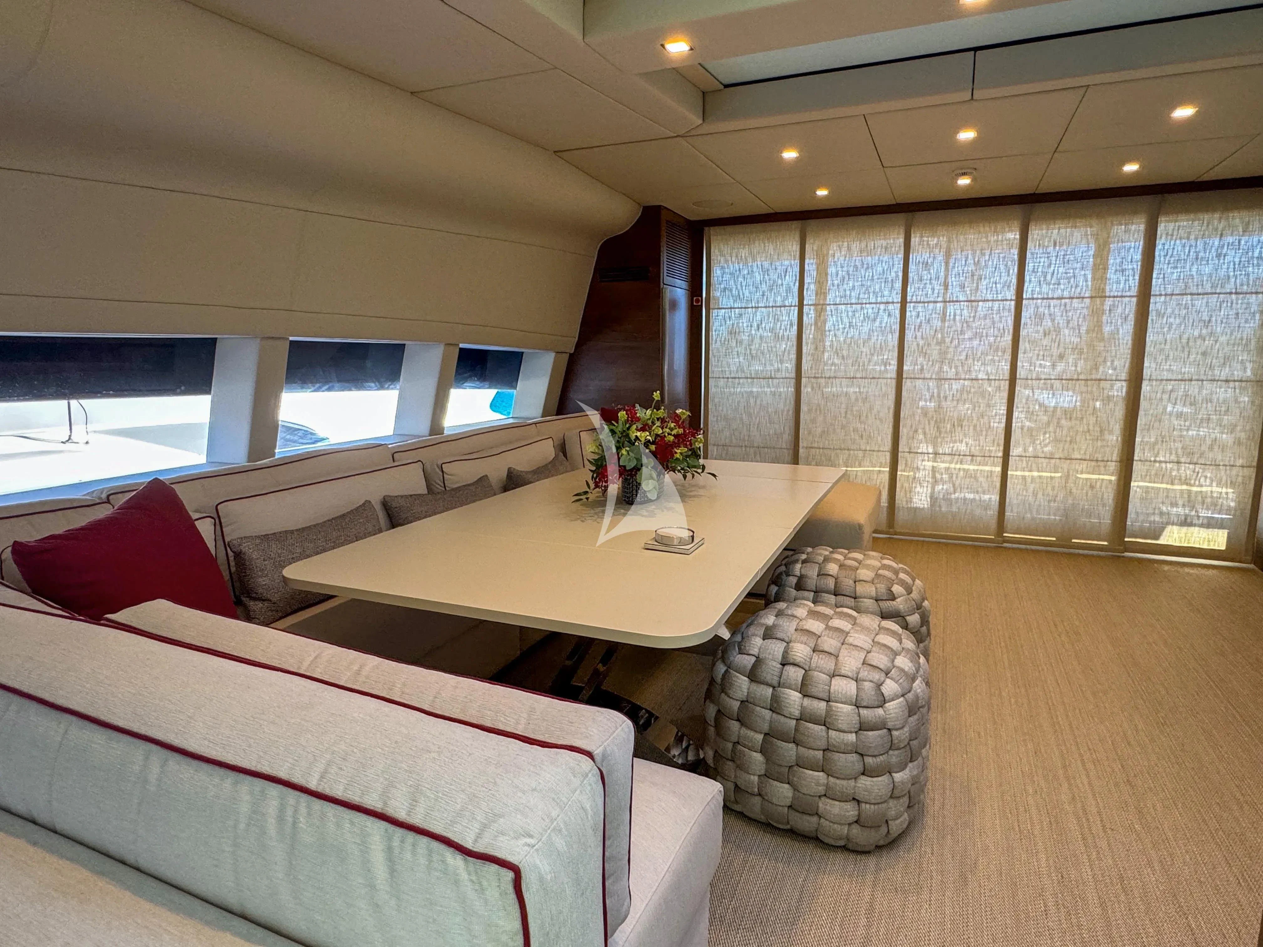 a room with a table and chairs aboard NAIA Yacht for Sale