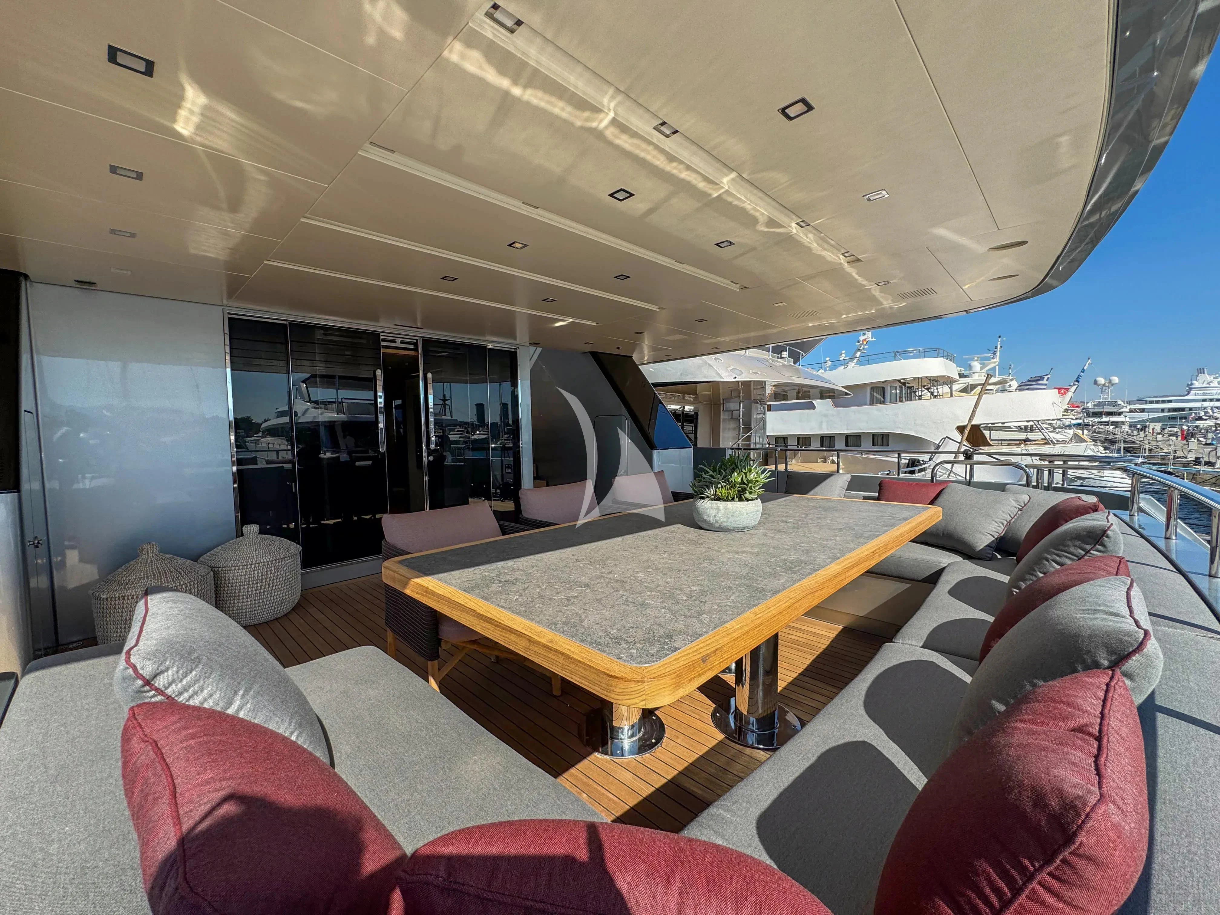 a large living room with a table and chairs aboard NAIA Yacht for Sale