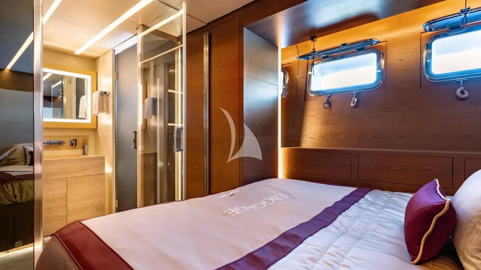 a bedroom with a bed and a window aboard NAIA Yacht for Sale