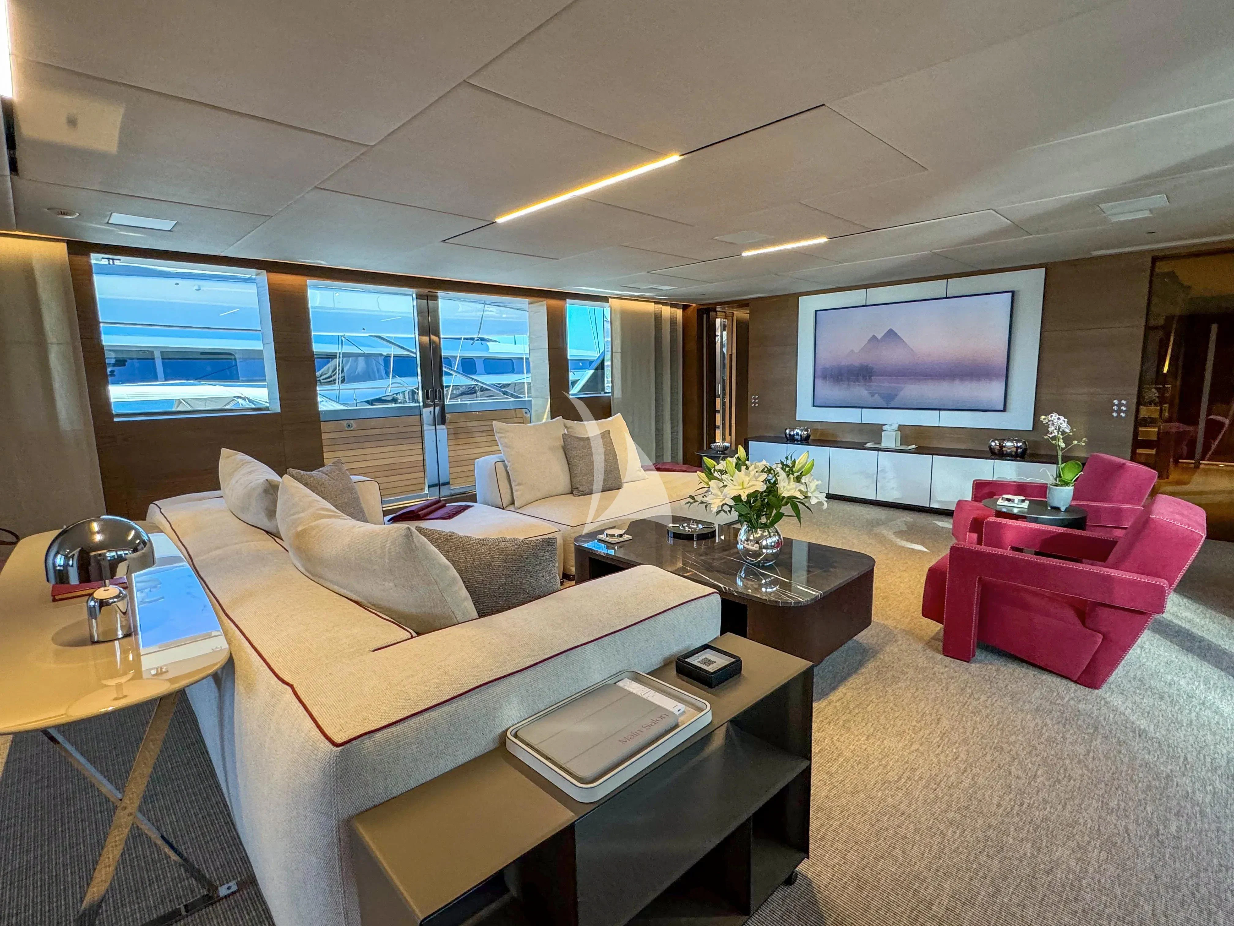 a living room with a large screen aboard NAIA Yacht for Sale