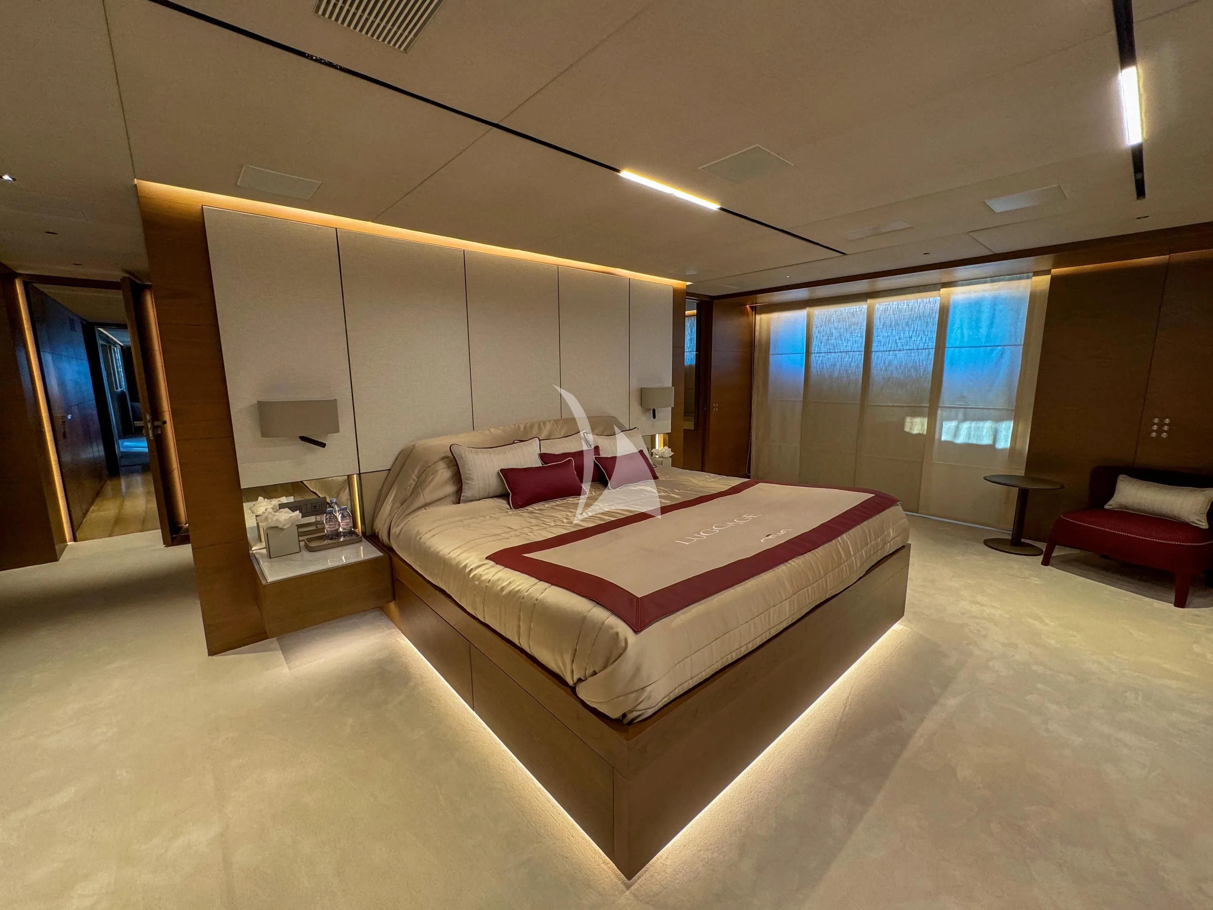 a room with a bed and a desk aboard NAIA Yacht for Sale