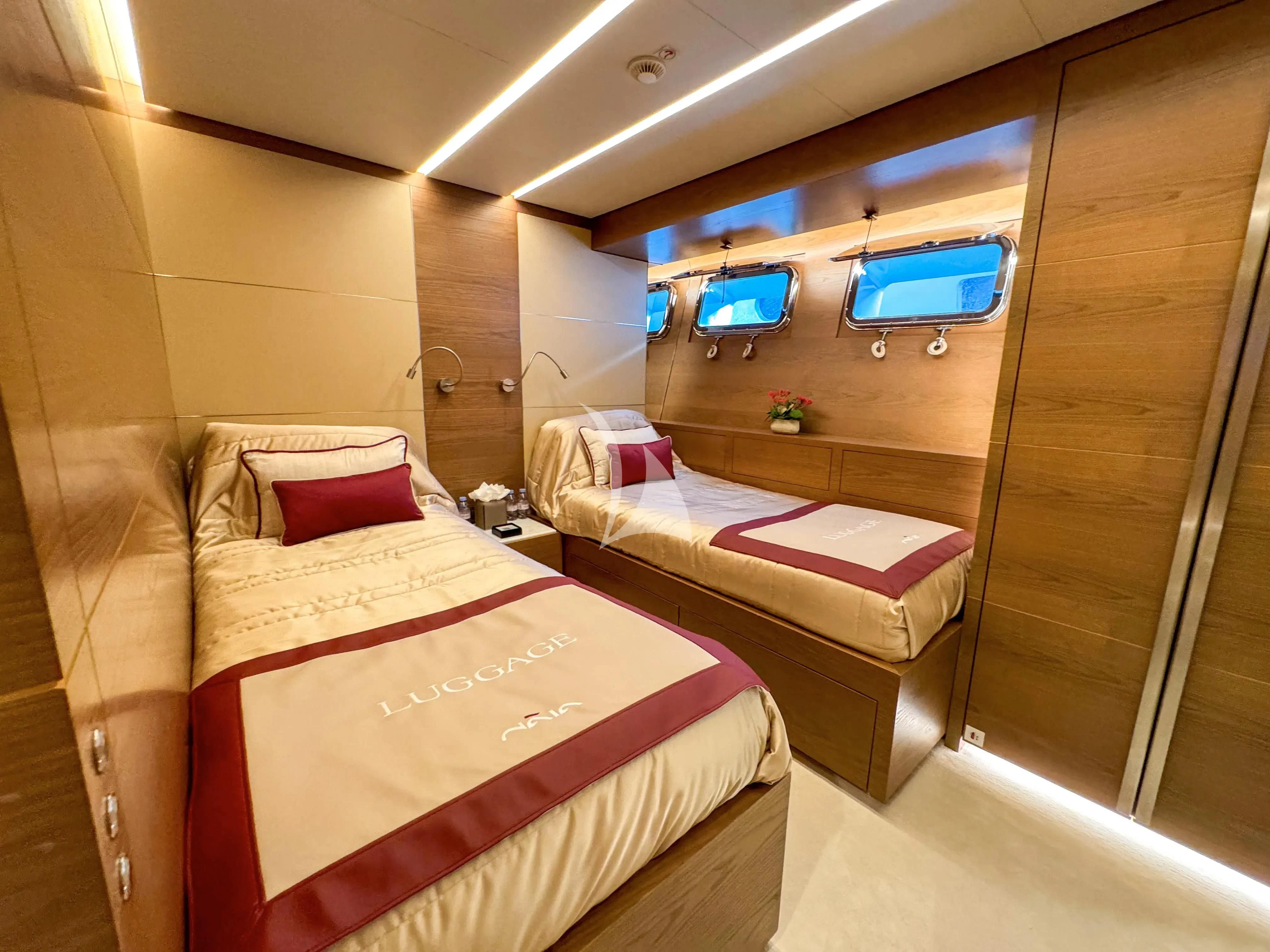 a room with a bed and a tv aboard NAIA Yacht for Sale