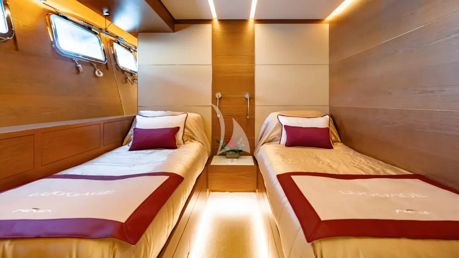 a room with beds and a tv aboard NAIA Yacht for Sale
