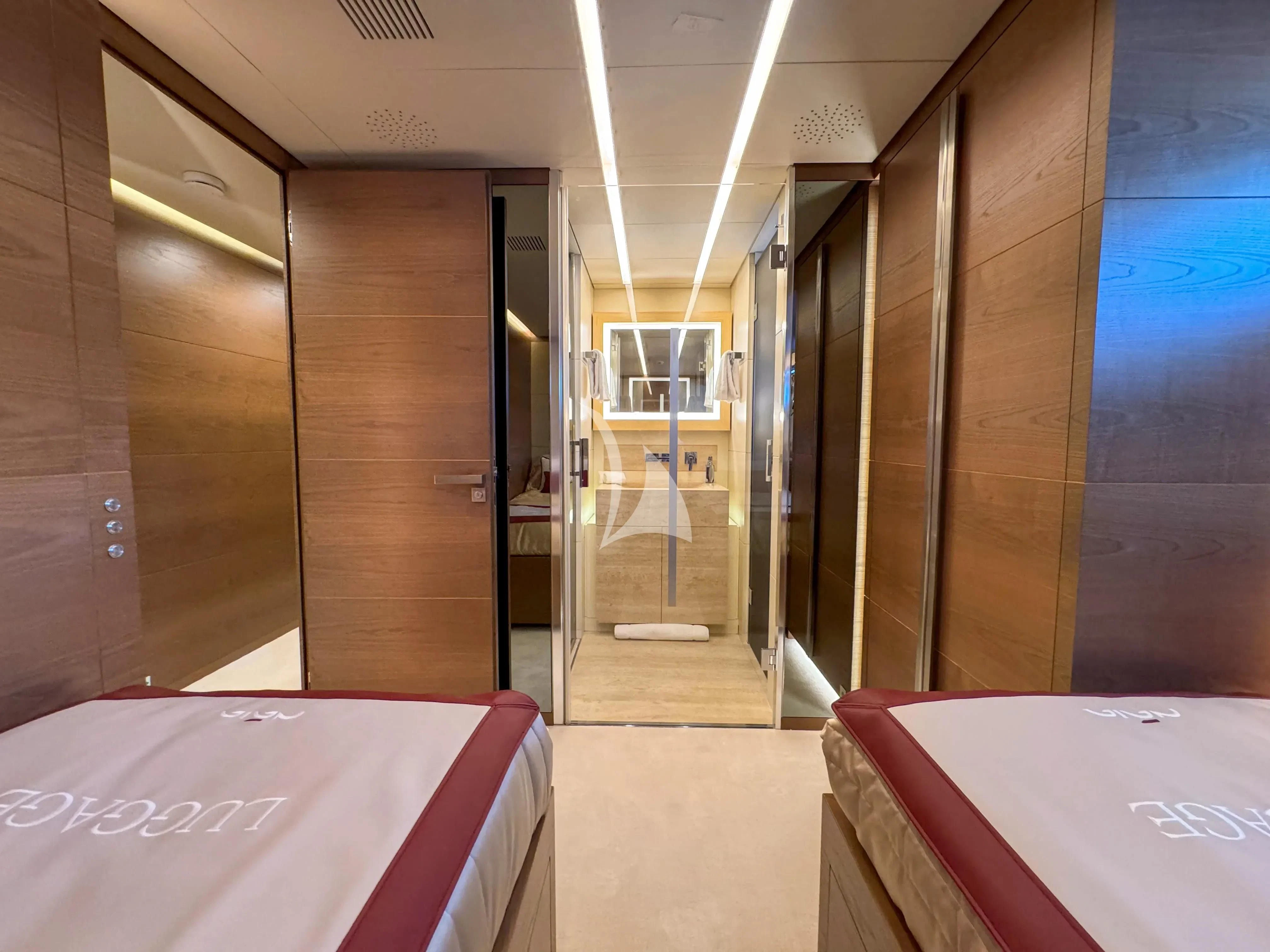a room with a bed and a table aboard NAIA Yacht for Sale