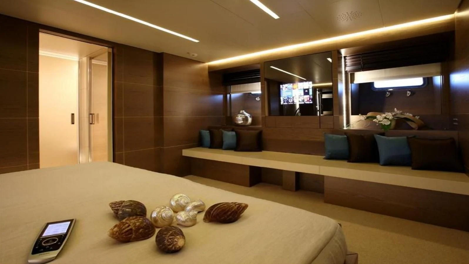 a room with a table and a couch aboard NAIA Yacht for Sale