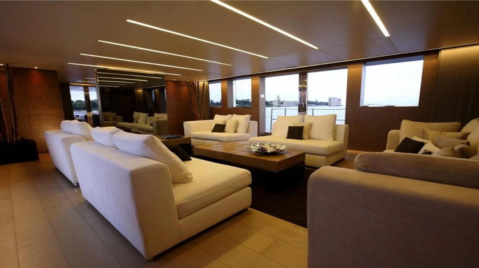 a room with a couch and a table and a window aboard NAIA Yacht for Sale