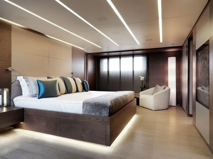 a large bedroom with a large bed aboard NAIA Yacht for Sale