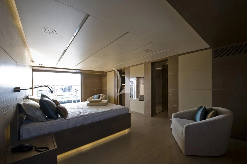 a bedroom with a bed and a couch aboard NAIA Yacht for Sale