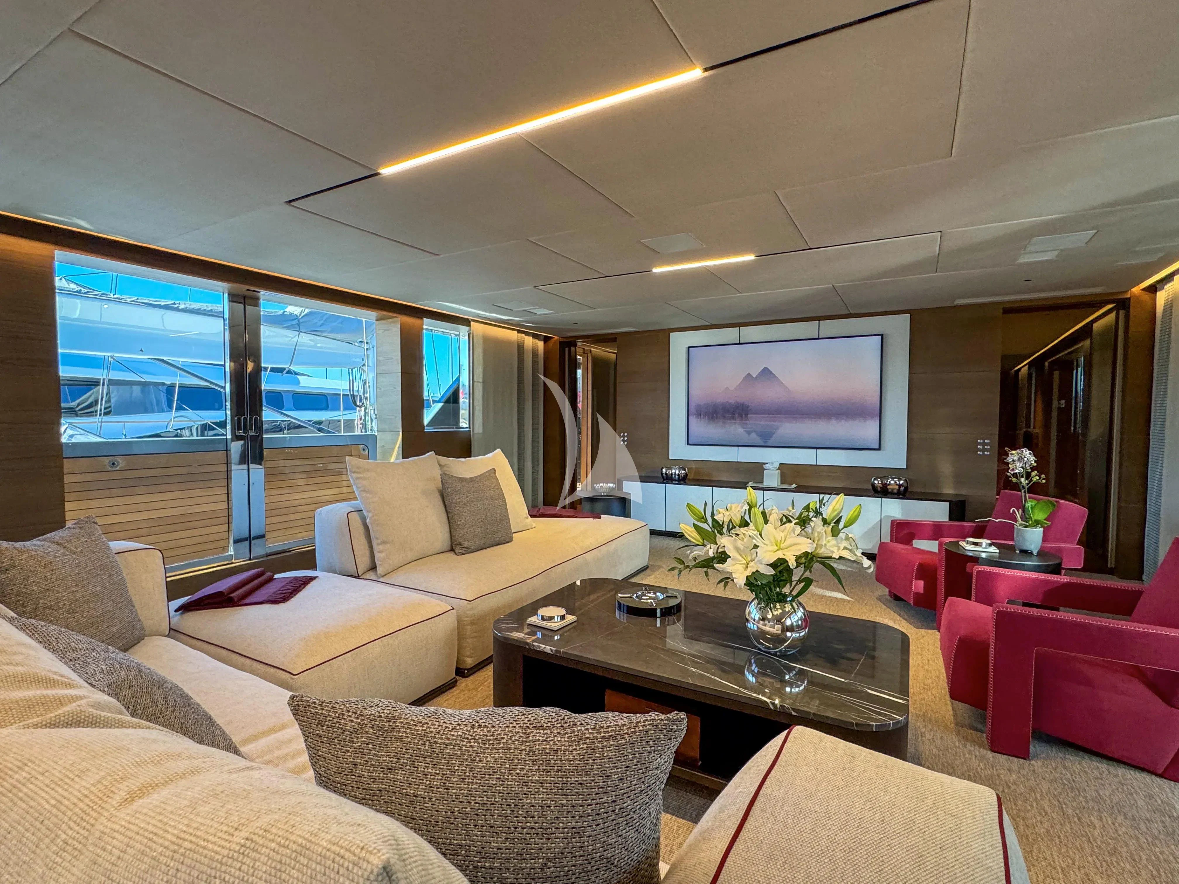 a living room with a large screen aboard NAIA Yacht for Sale