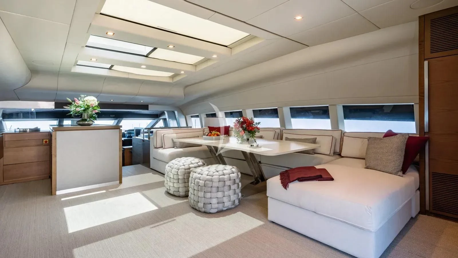 a room with a couch and a table and a tv aboard NAIA Yacht for Sale