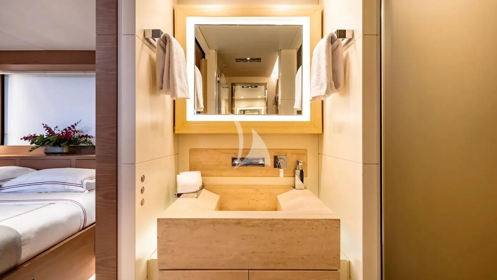 a bathroom with a mirror and a bed aboard NAIA Yacht for Sale