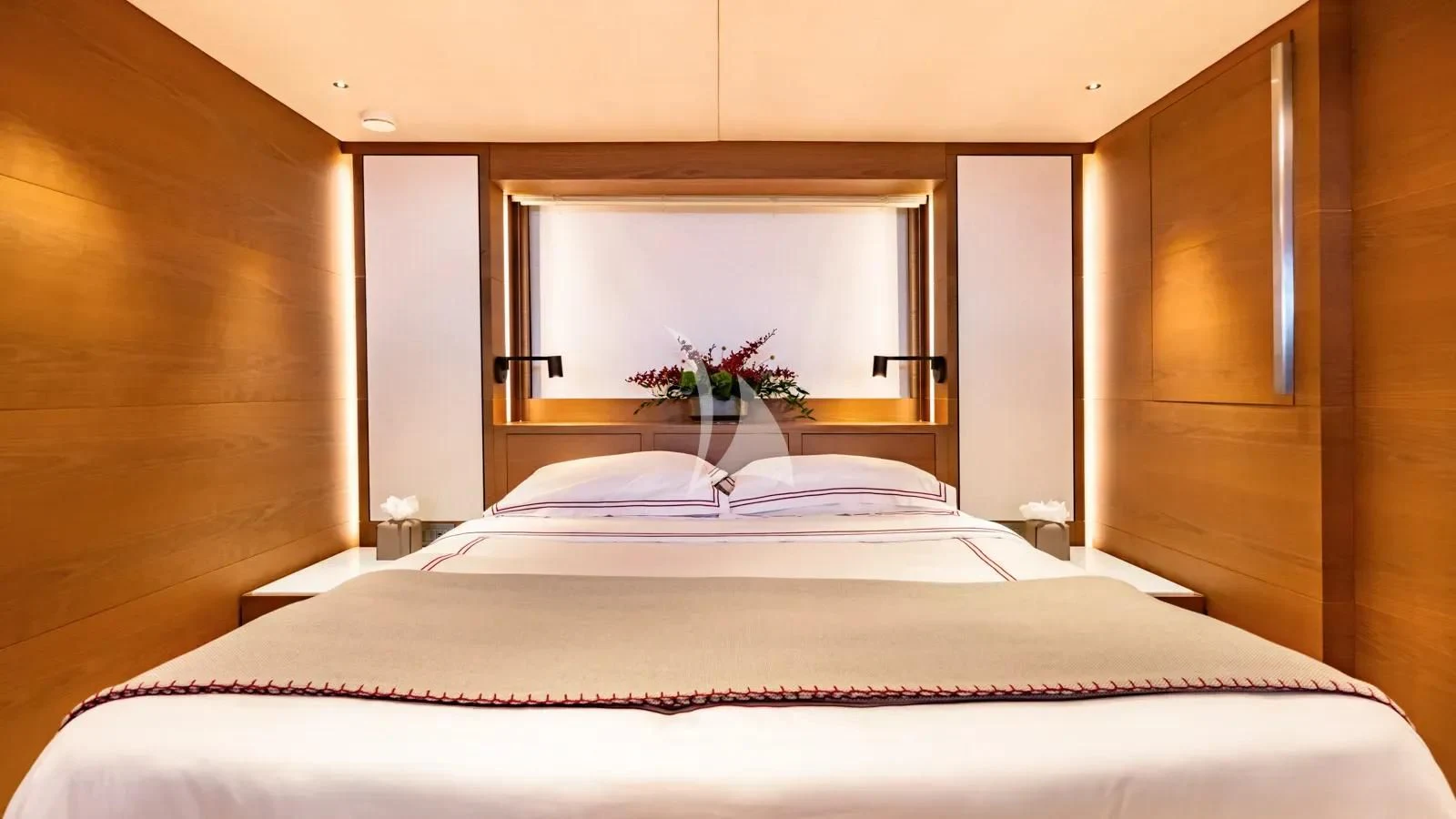 a bed with a flower on the bed aboard NAIA Yacht for Sale