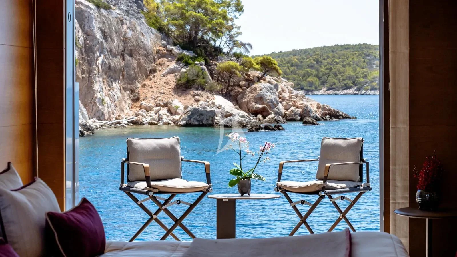 a table and chairs on a patio aboard NAIA Yacht for Sale