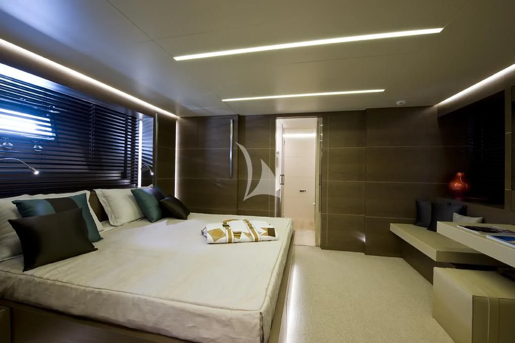 a room with a bed and a desk aboard NAIA Yacht for Sale