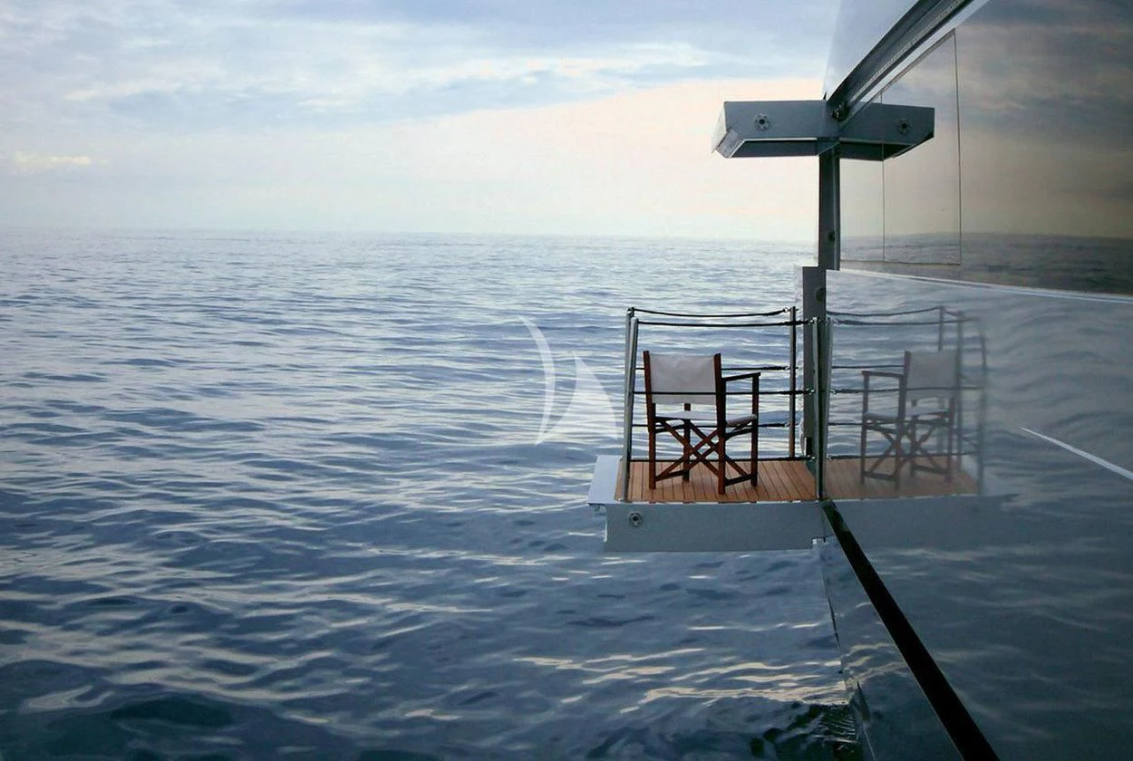 a chair on a dock in the water aboard NAIA Yacht for Sale