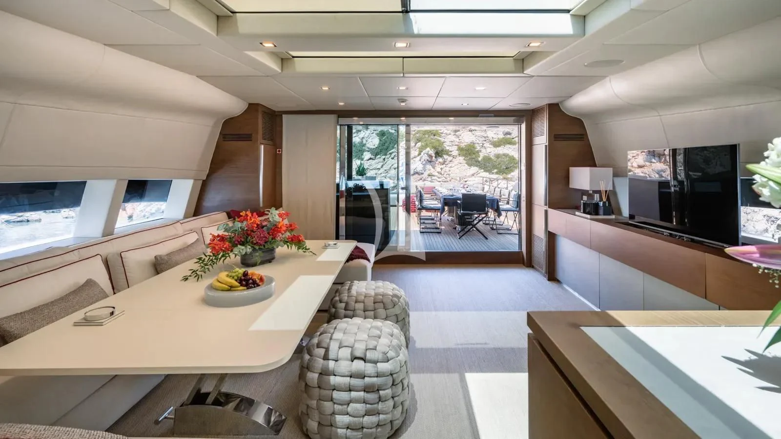 a room with a table chairs and a tv aboard NAIA Yacht for Sale