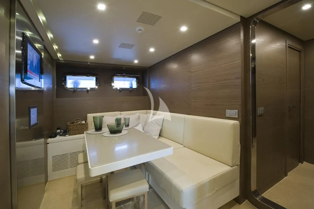 a room with a table and chairs aboard NAIA Yacht for Sale