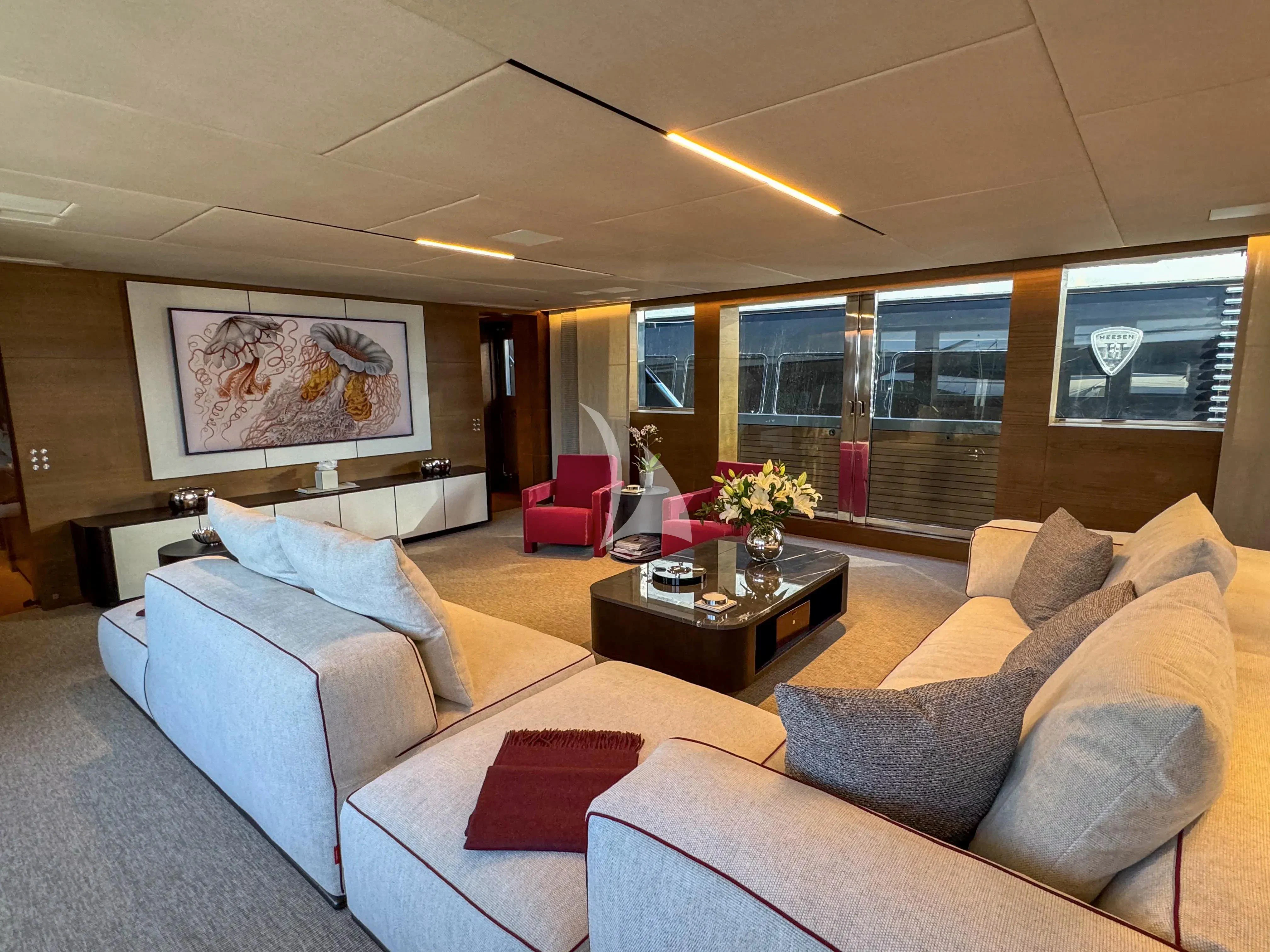 a living room with a couch and a table aboard NAIA Yacht for Sale