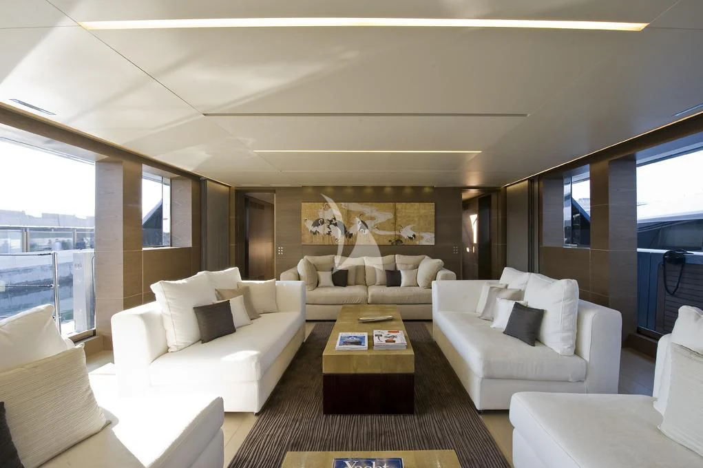 a living room with white furniture aboard NAIA Yacht for Sale