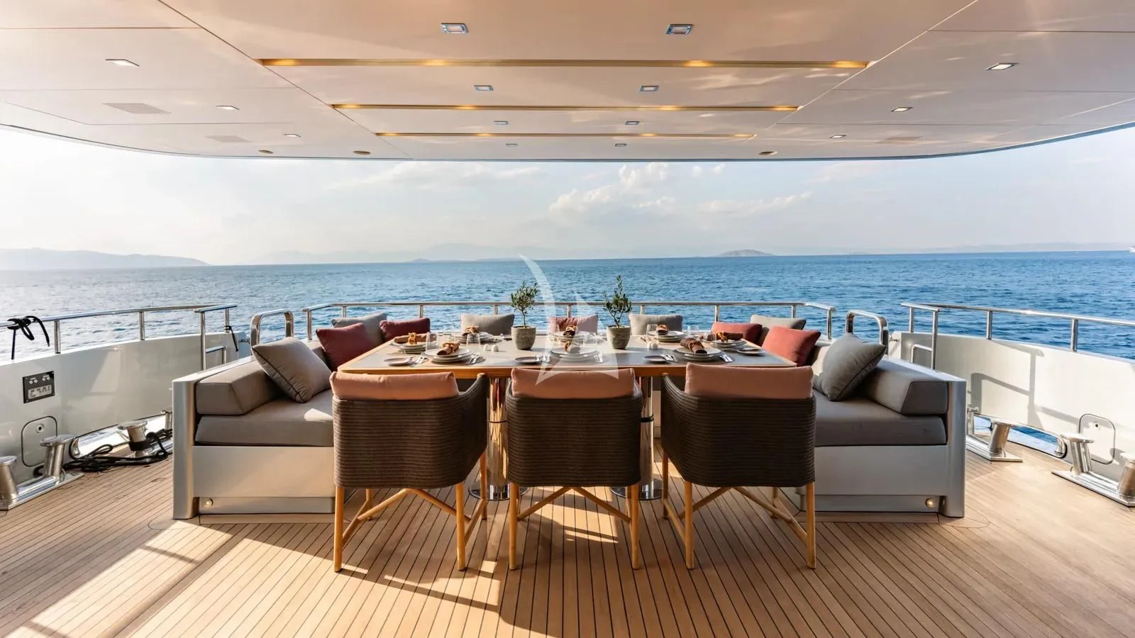 a large patio with a table and chairs on it aboard NAIA Yacht for Sale