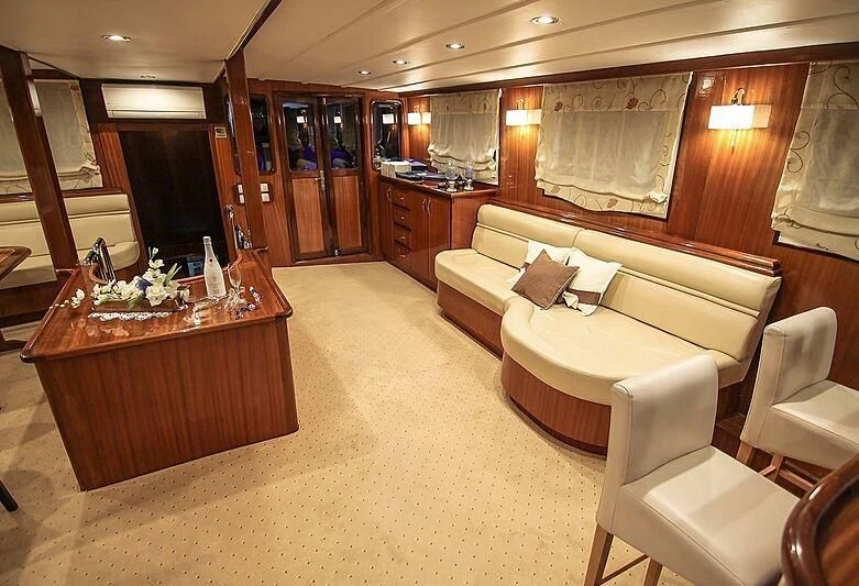 a living room with a couch and a table aboard AURUM Yacht for Sale