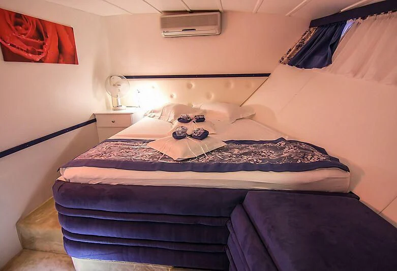 a couple of beds in a room aboard AURUM Yacht for Sale