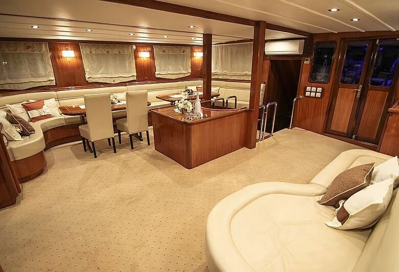 a large room with a bed and a table aboard AURUM Yacht for Sale