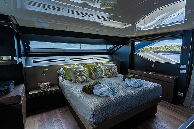 a room with a bed and a window aboard NOOR II Yacht for Charter