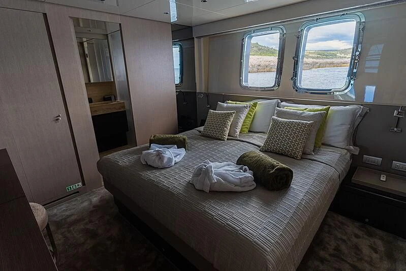 a bed with pillows on it aboard NOOR II Yacht for Charter