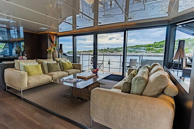 a living room with a large window aboard NOOR II Yacht for Charter