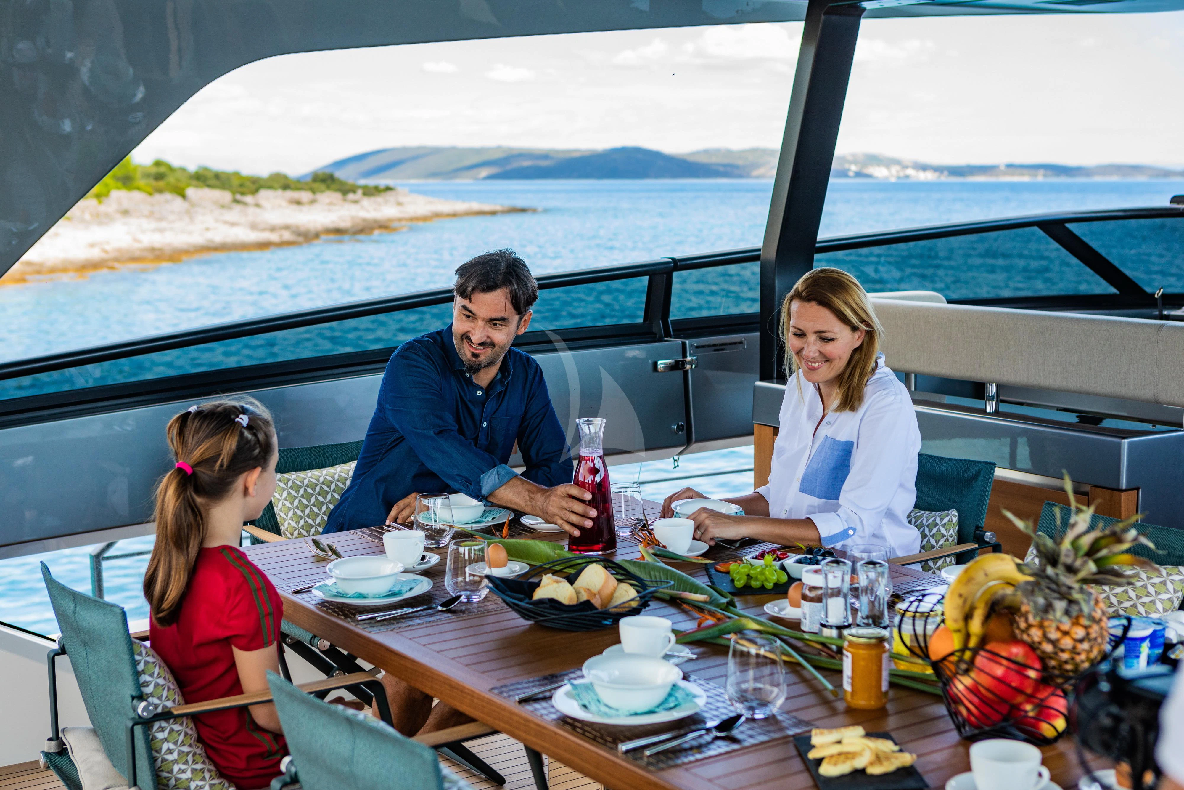 a family sitting at a table aboard NOOR II Yacht for Charter