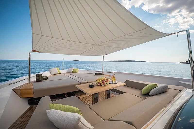 a room with a table and chairs on it by the ocean aboard NOOR II Yacht for Charter