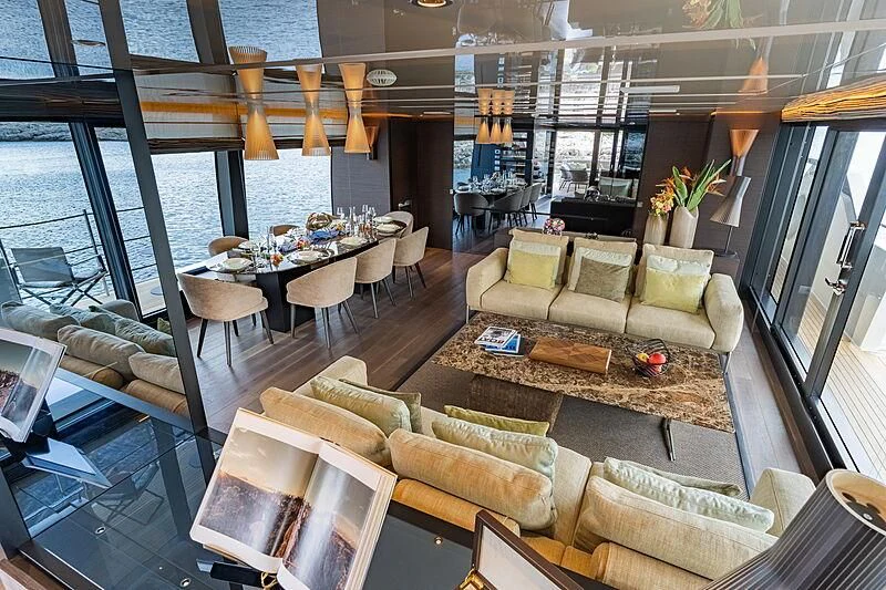 a living room with a large window aboard NOOR II Yacht for Charter