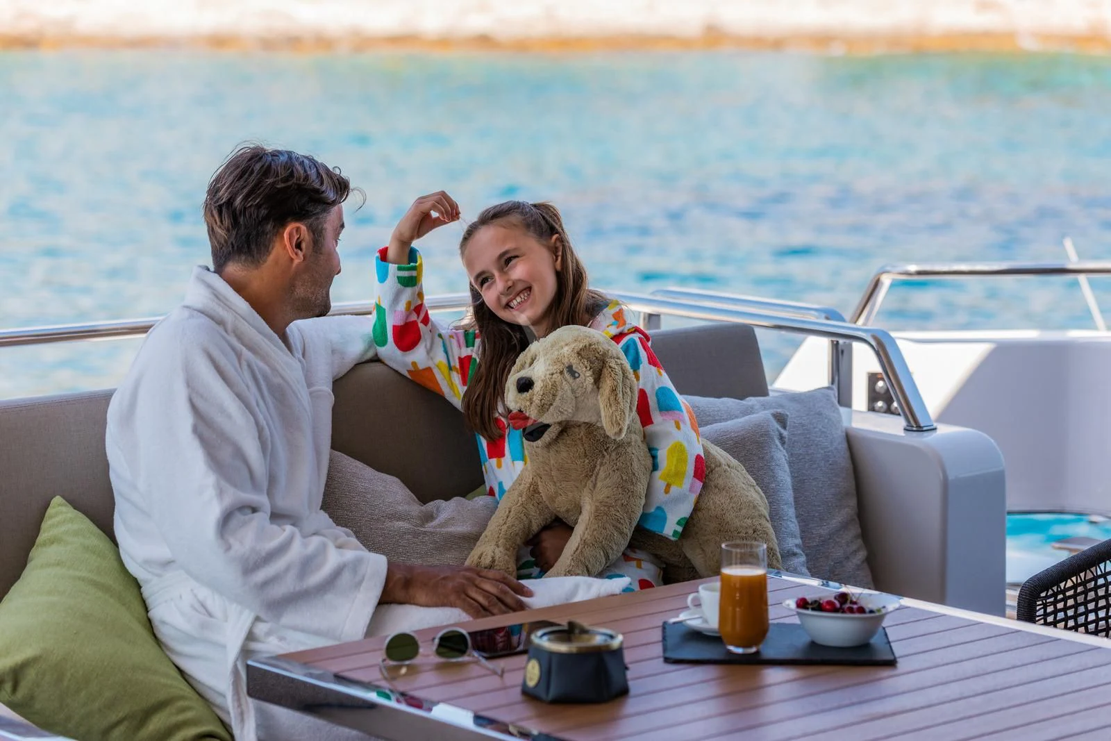 a man and a woman sitting on a boat with a dog aboard NOOR II Yacht for Charter