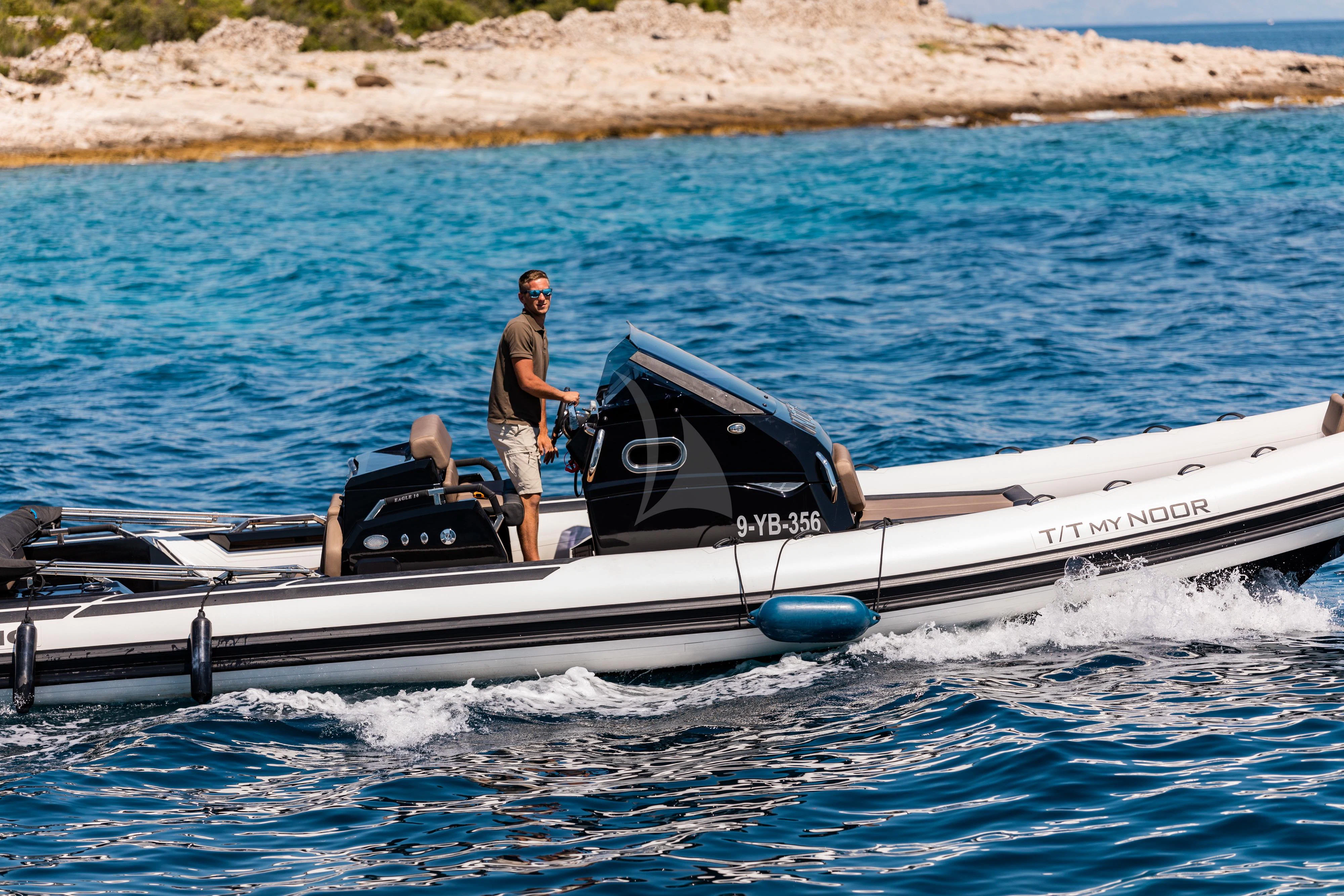 a person standing on a boat aboard NOOR II Yacht for Charter