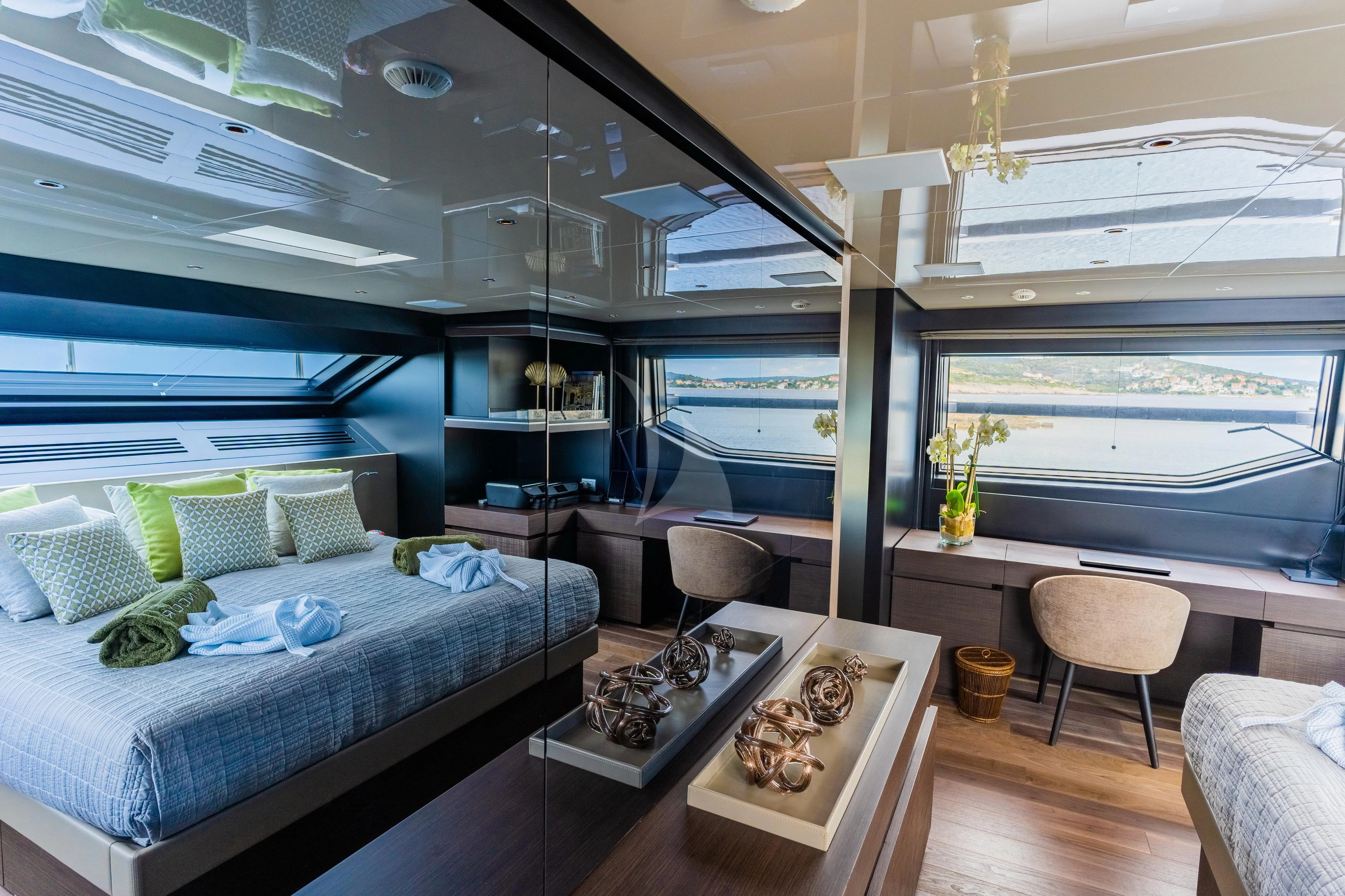 a room with a bed and a table aboard NOOR II Yacht for Charter
