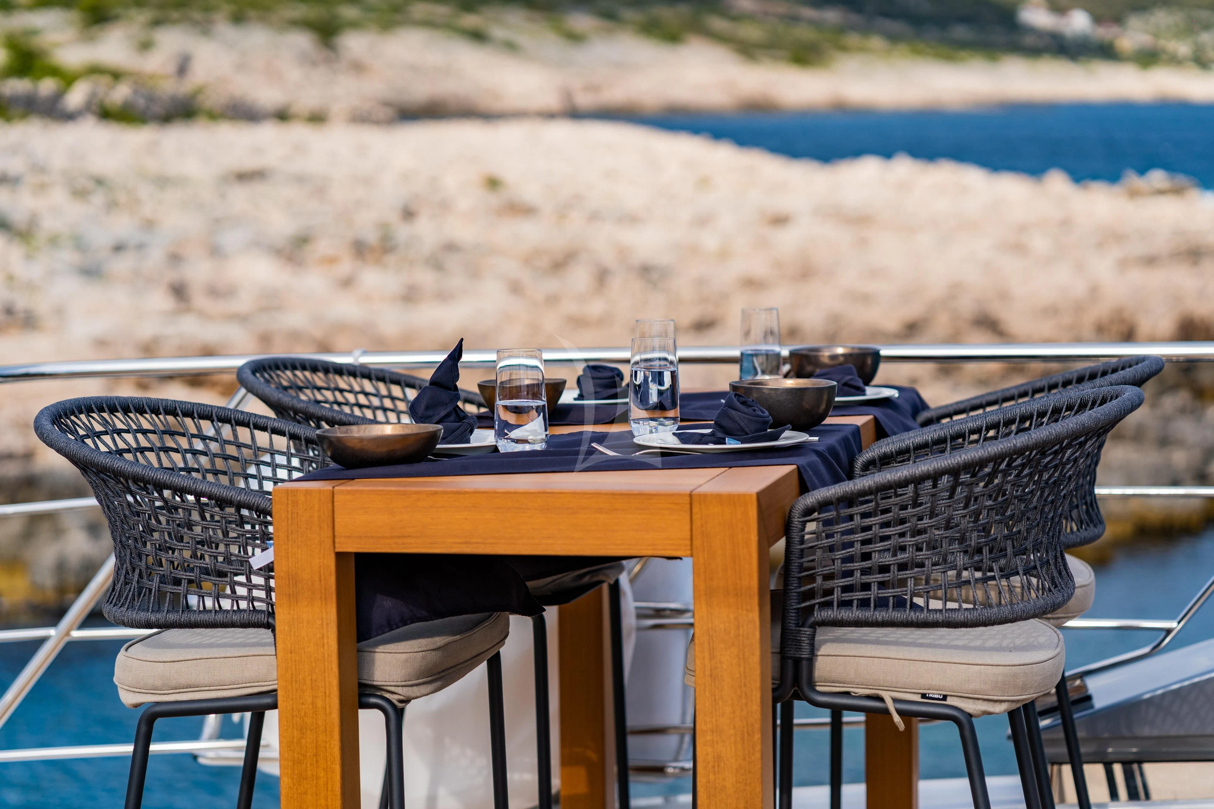a table set with food and drinks aboard NOOR II Yacht for Charter