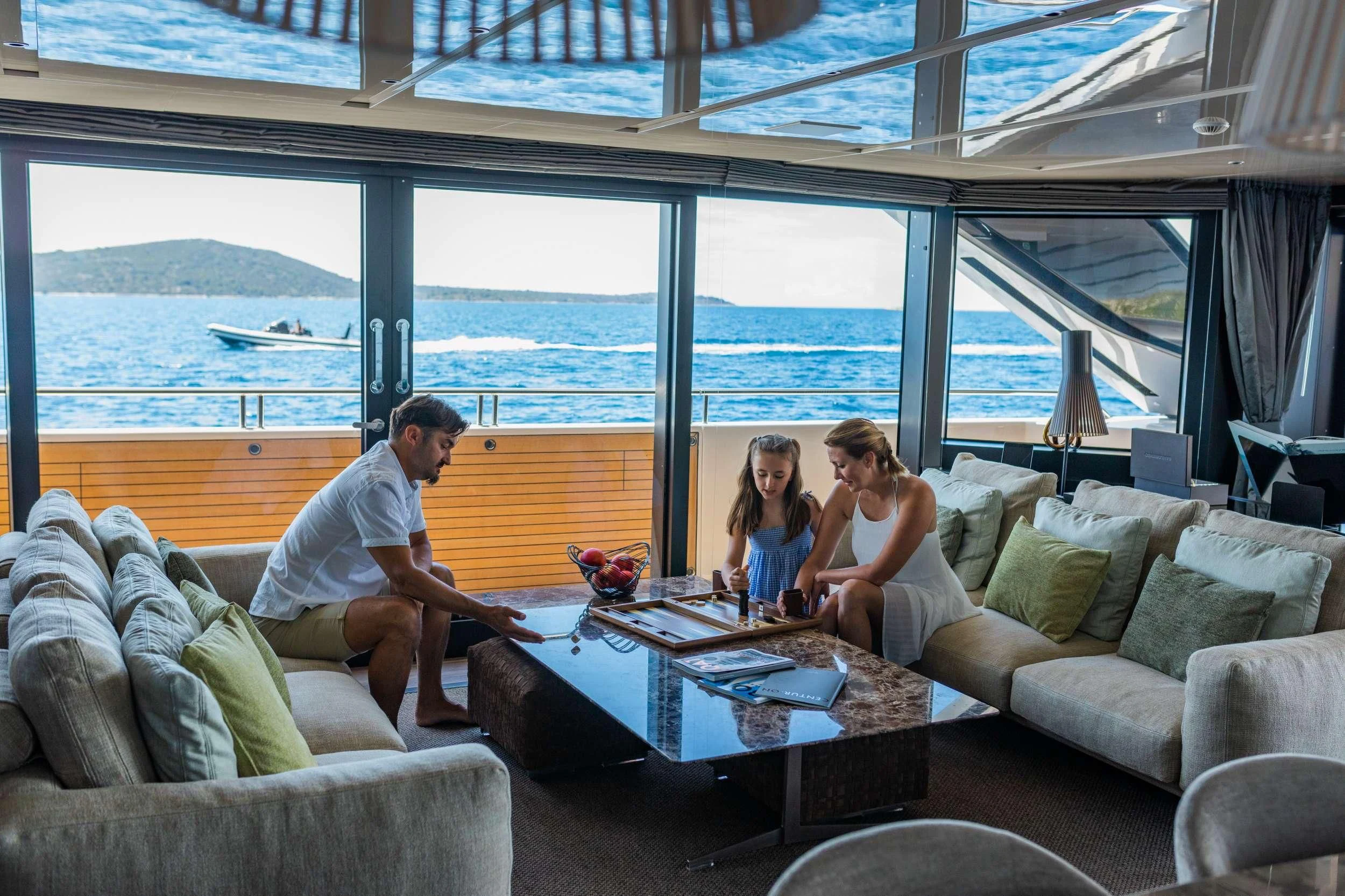 a family sitting on a couch aboard NOOR II Yacht for Charter