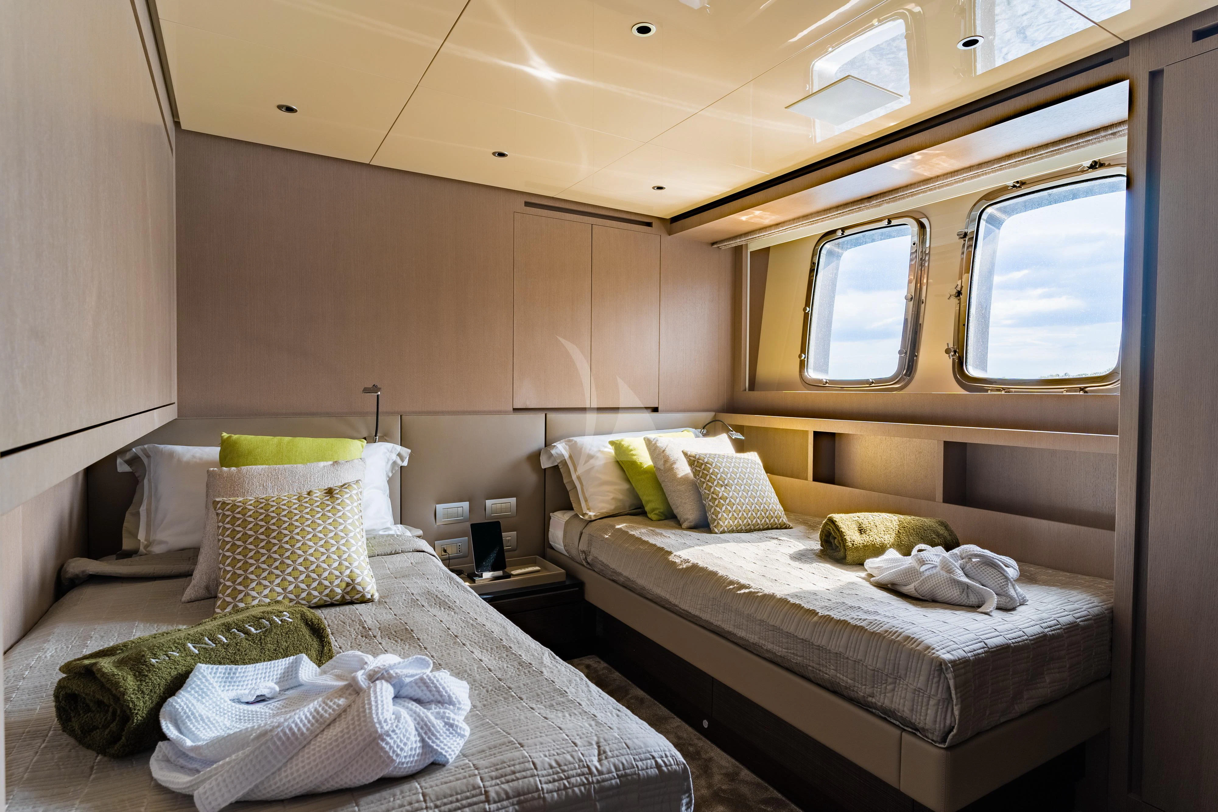 a couple of beds in a room aboard NOOR II Yacht for Charter