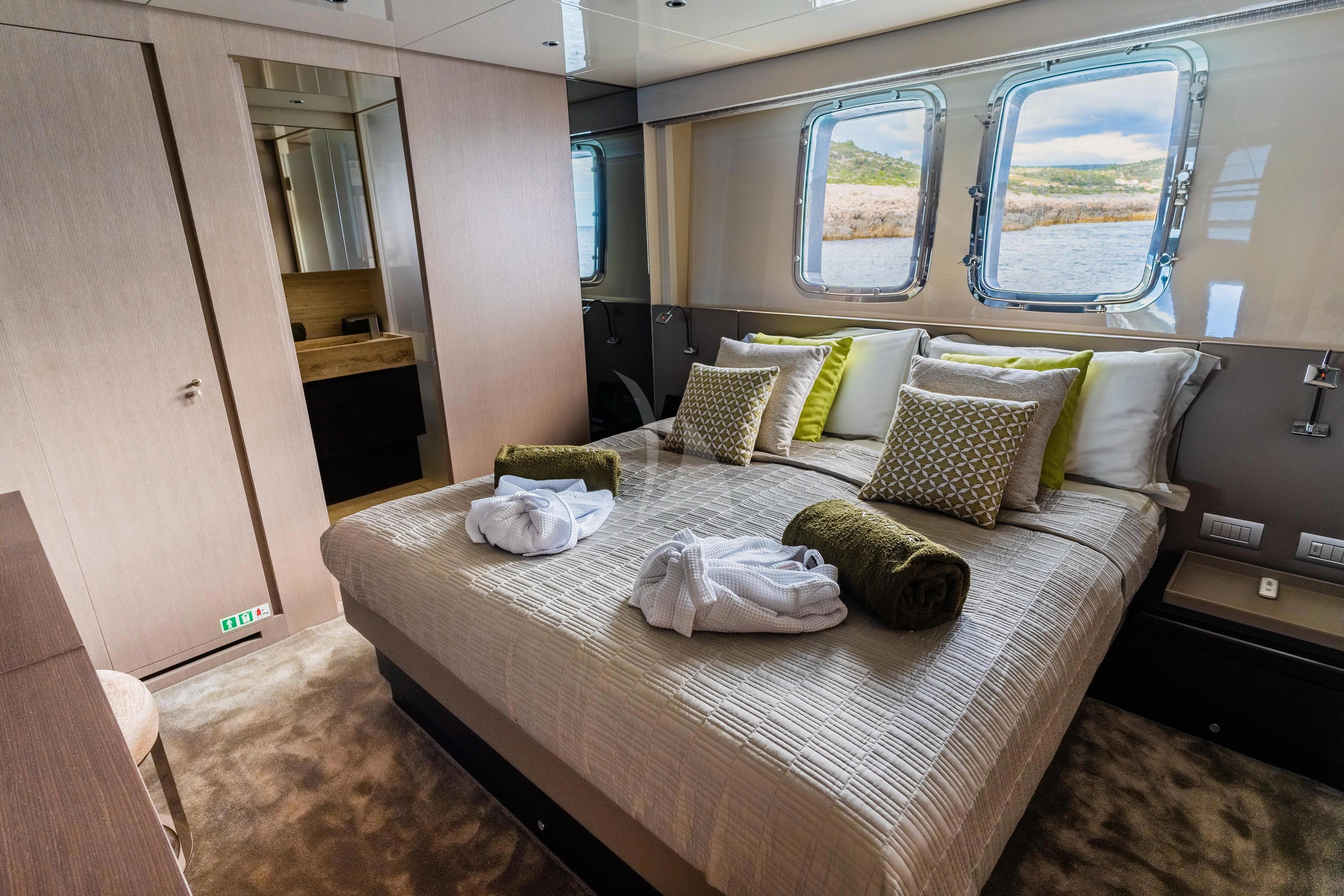 a bed with pillows on it aboard NOOR II Yacht for Charter