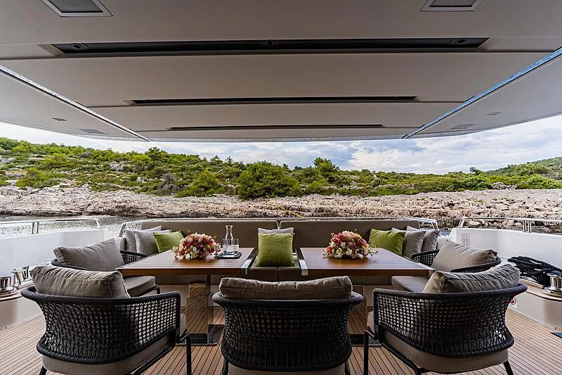 a patio with a table and chairs aboard NOOR II Yacht for Charter