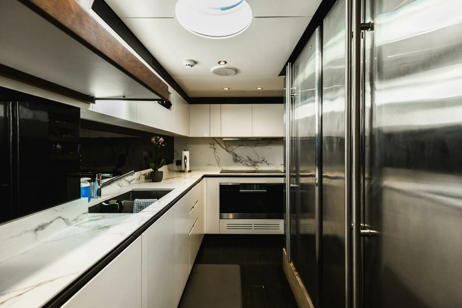 a kitchen with a glass door aboard MAJESTIC MOMENTS Yacht for Sale