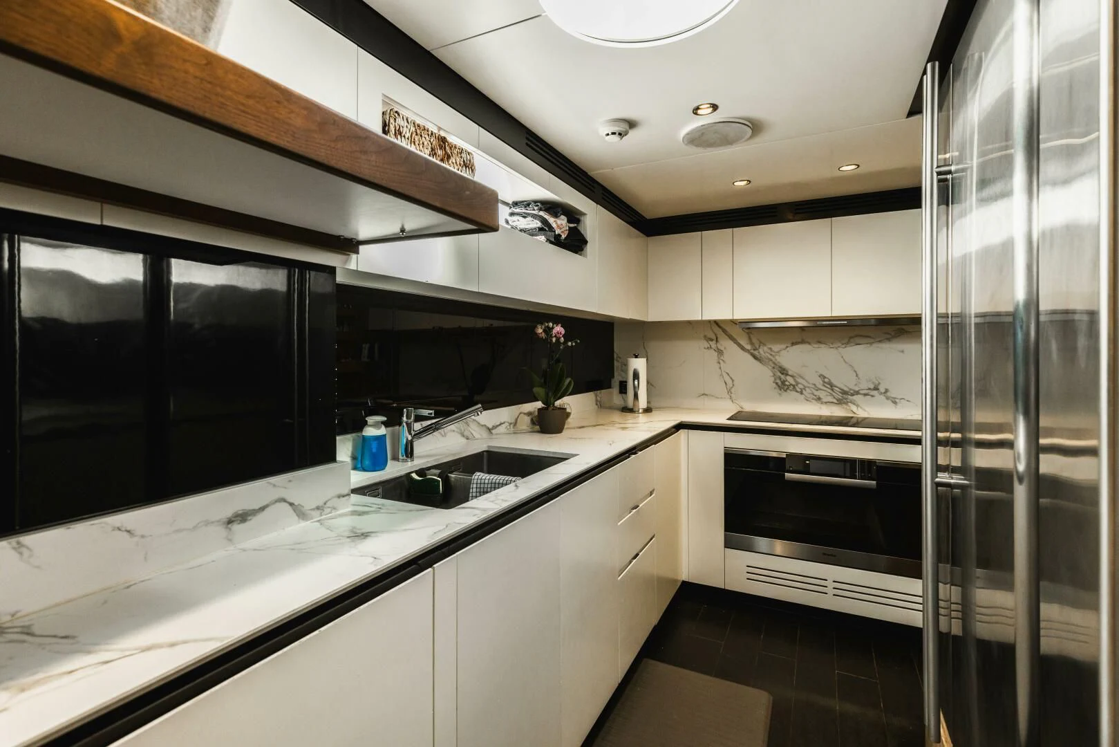 a kitchen with a glass shower aboard MAJESTIC MOMENTS Yacht for Sale