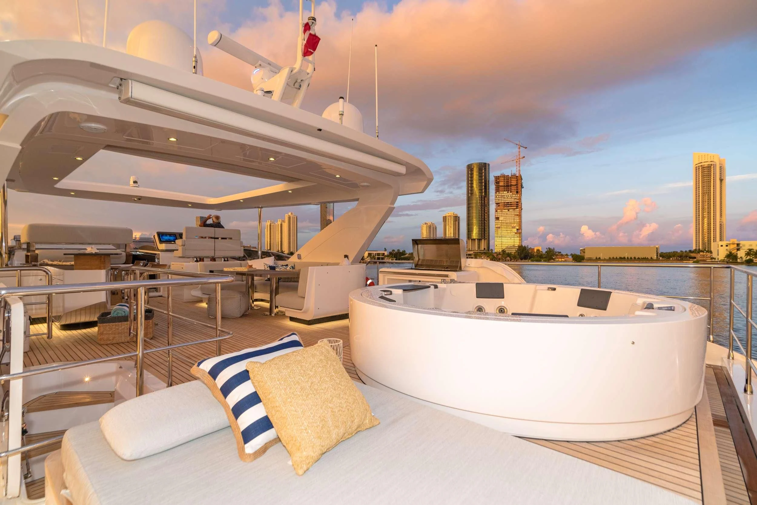 a large white bathtub in a room with a city skyline in the background aboard MAJESTIC MOMENTS Yacht for Sale