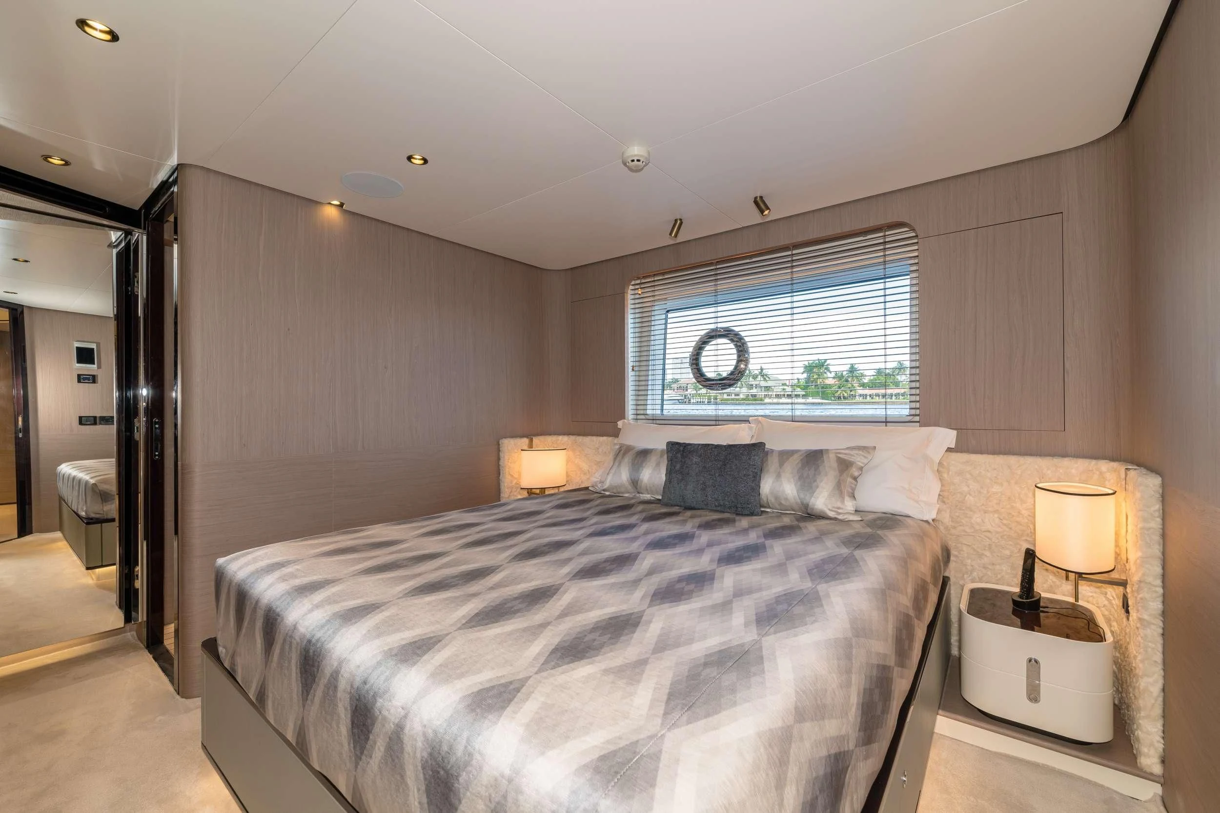 a bedroom with a bed and a window aboard MAJESTIC MOMENTS Yacht for Sale