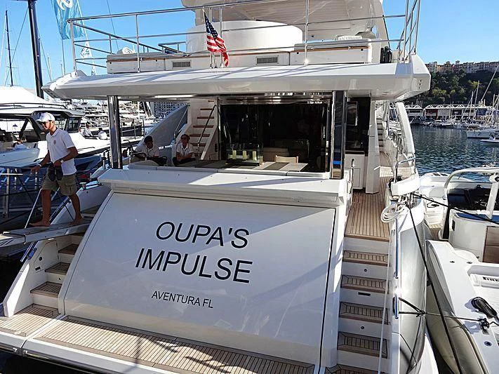 a boat with a flag on the front aboard MAJESTIC MOMENTS Yacht for Sale