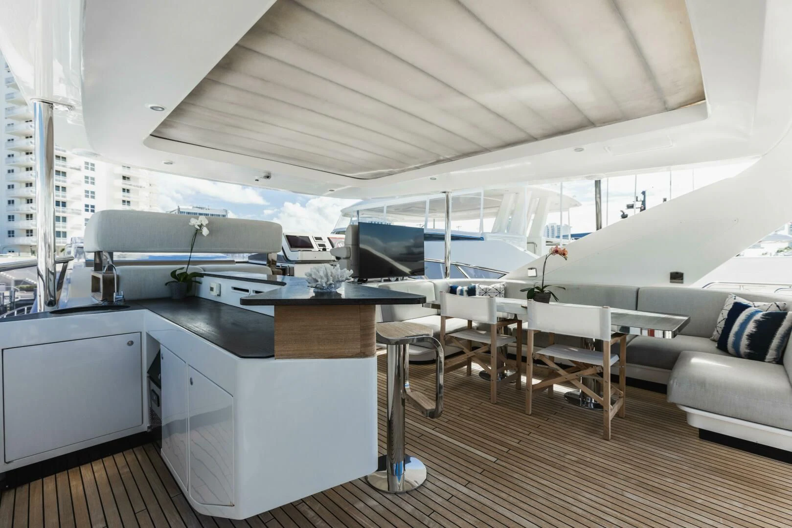 a room with a large white bed and a white couch aboard MAJESTIC MOMENTS Yacht for Sale