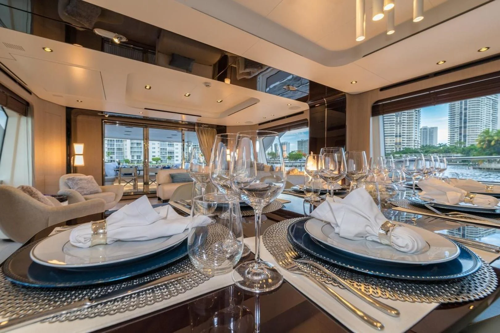 a table with plates and glasses on it aboard MAJESTIC MOMENTS Yacht for Sale